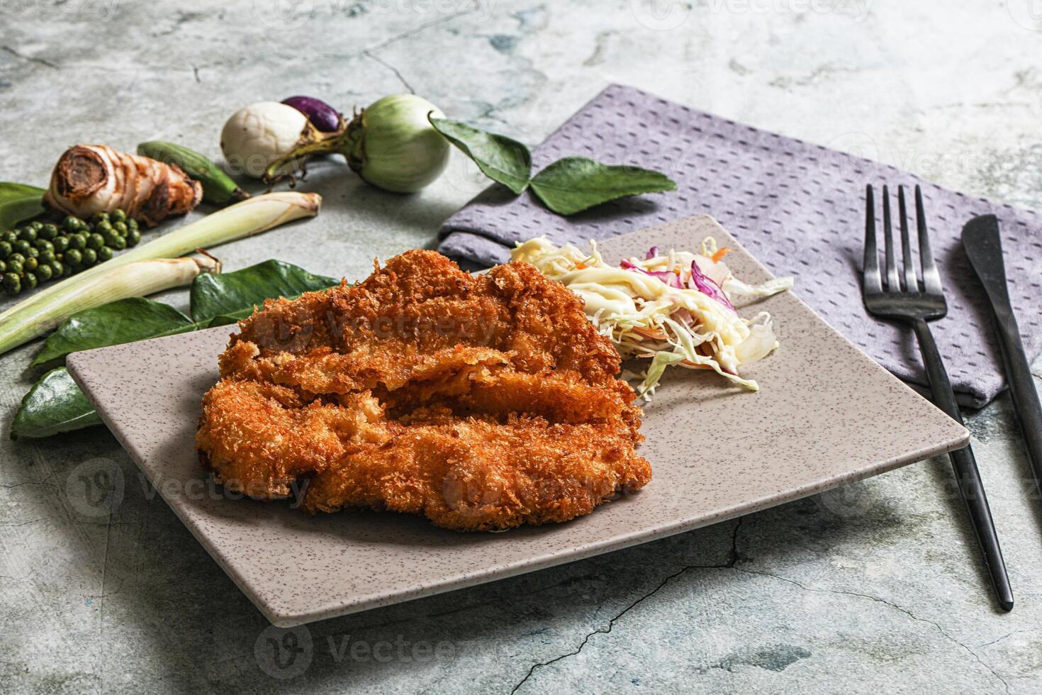 A plate with a piece of chicken on it photo