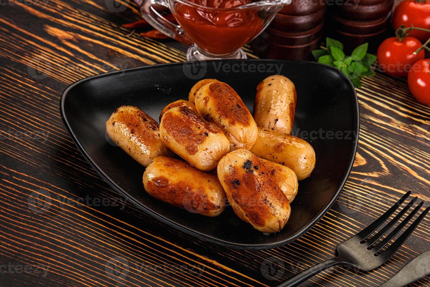 A black plate with some sausages on it photo