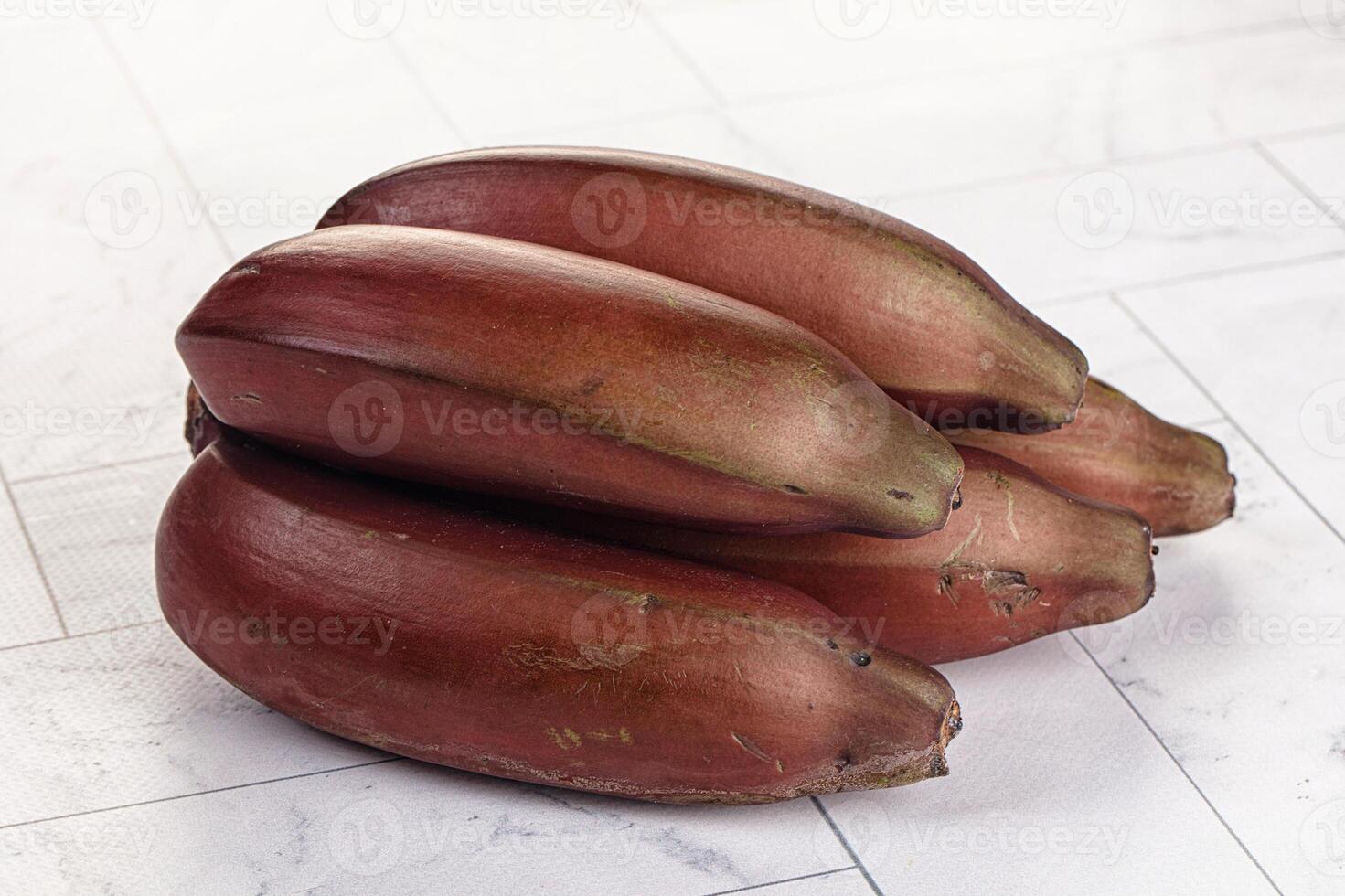 A pile of bananas on a white tile floor photo