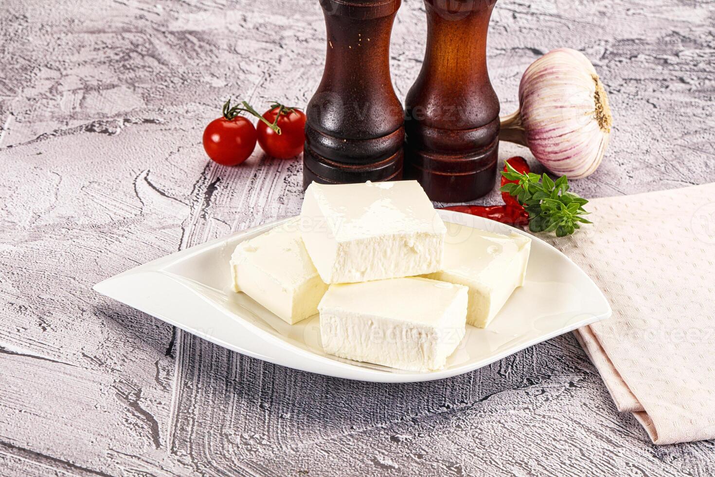A plate of cheese and garlic on a table photo