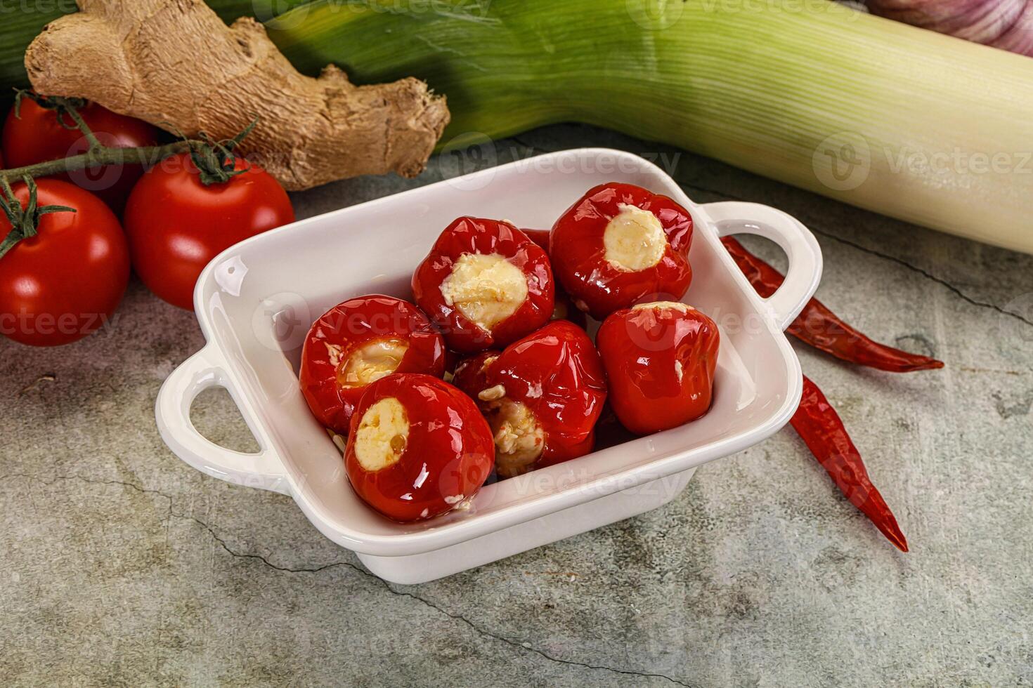 A white bowl filled with red peppers and garlic photo
