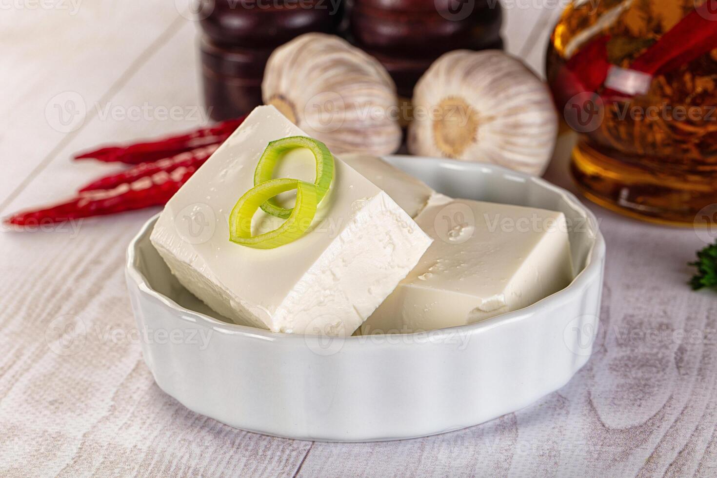 A bowl of tofu with green onions and garlic photo