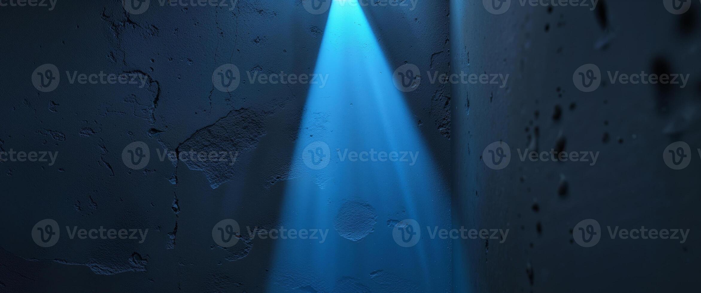 A blue light beam illuminating a textured dark wall photo