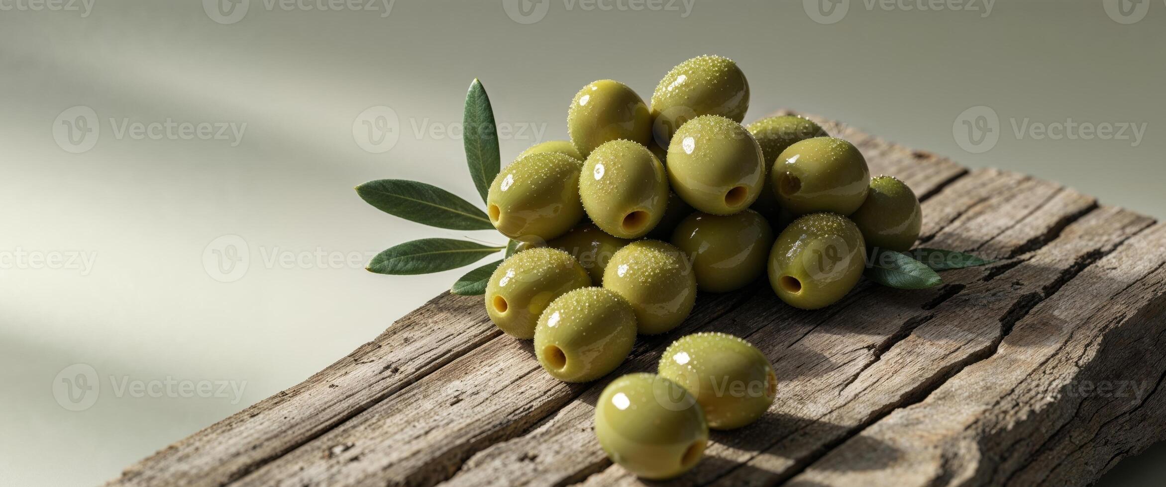 Fresh Green Olives with Natural Light on Rustic Wooden Surface photo
