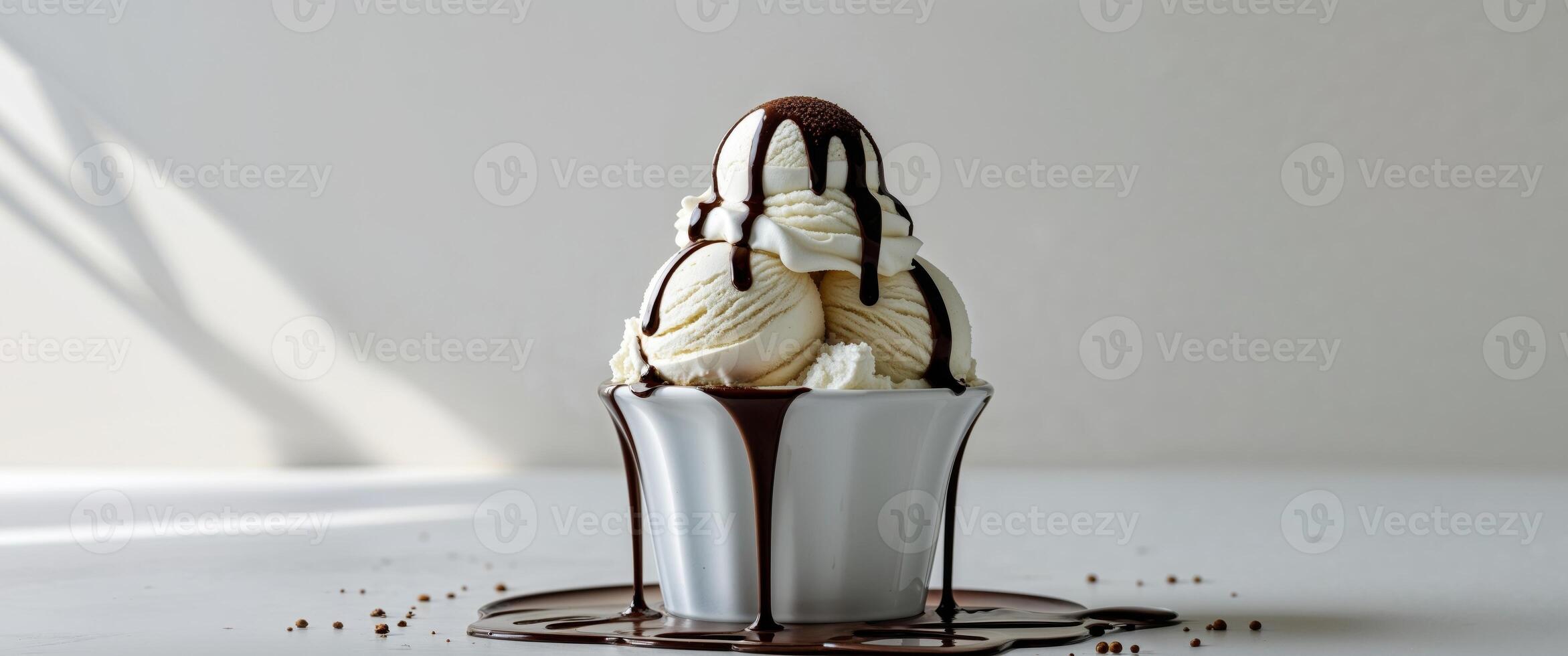 Ice cream with chocolate drips on white table photo