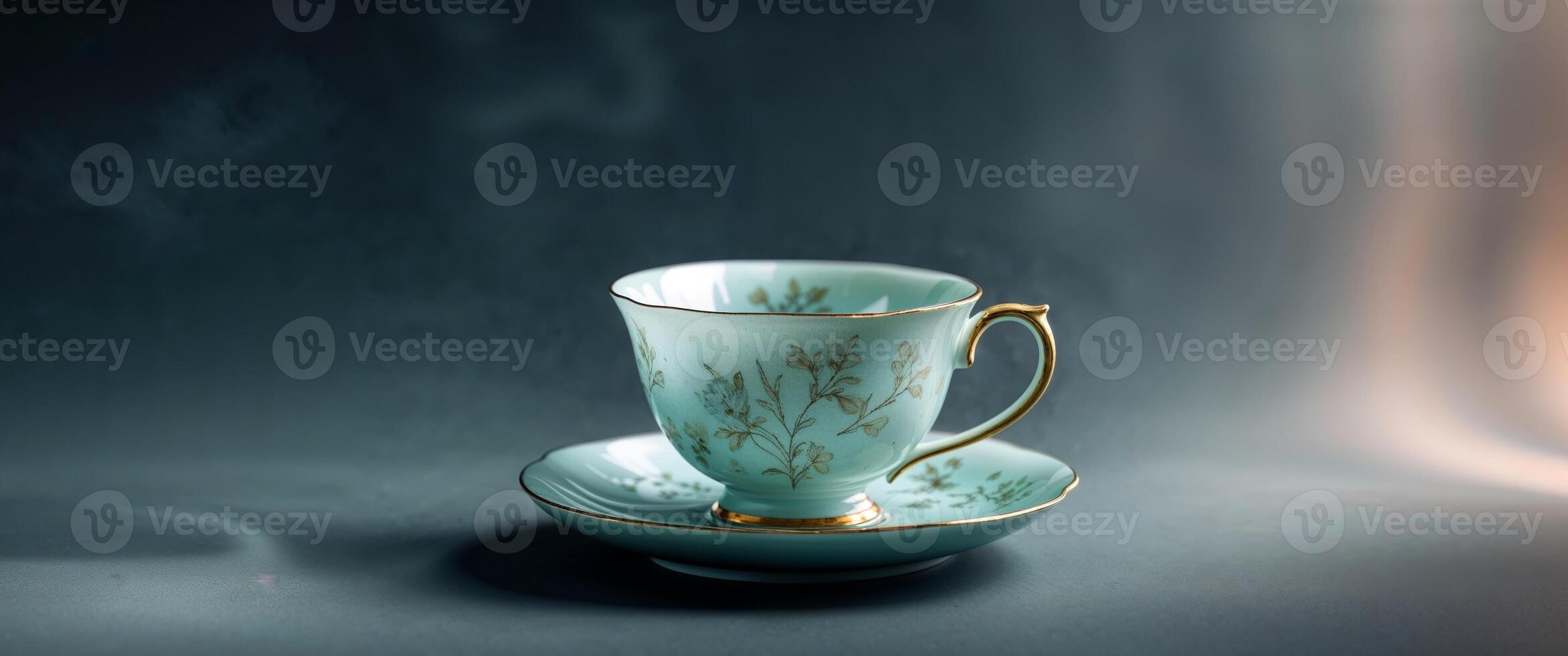 A cup and saucer with gold trim on a dark background photo