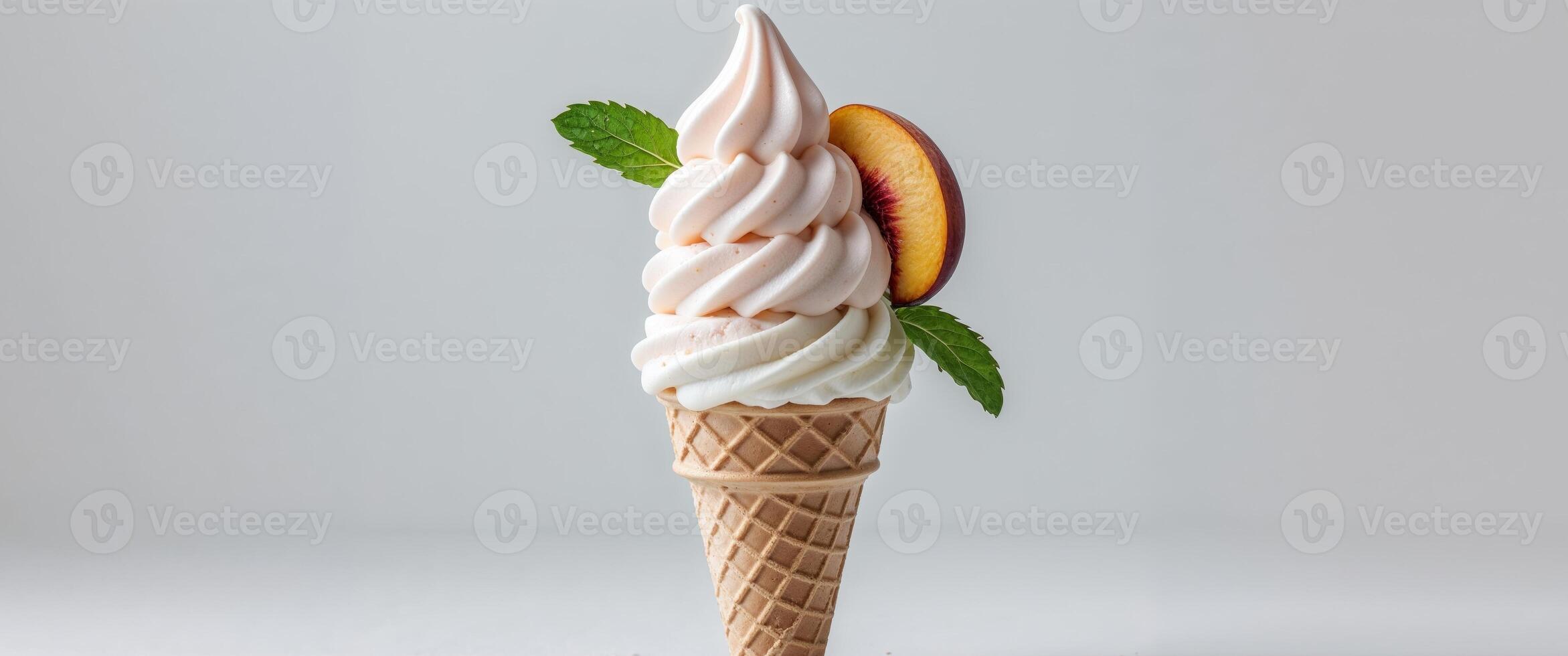 Delicious ice cream cone topped with creamy swirl and garnished with peach slice and mint leaf. photo