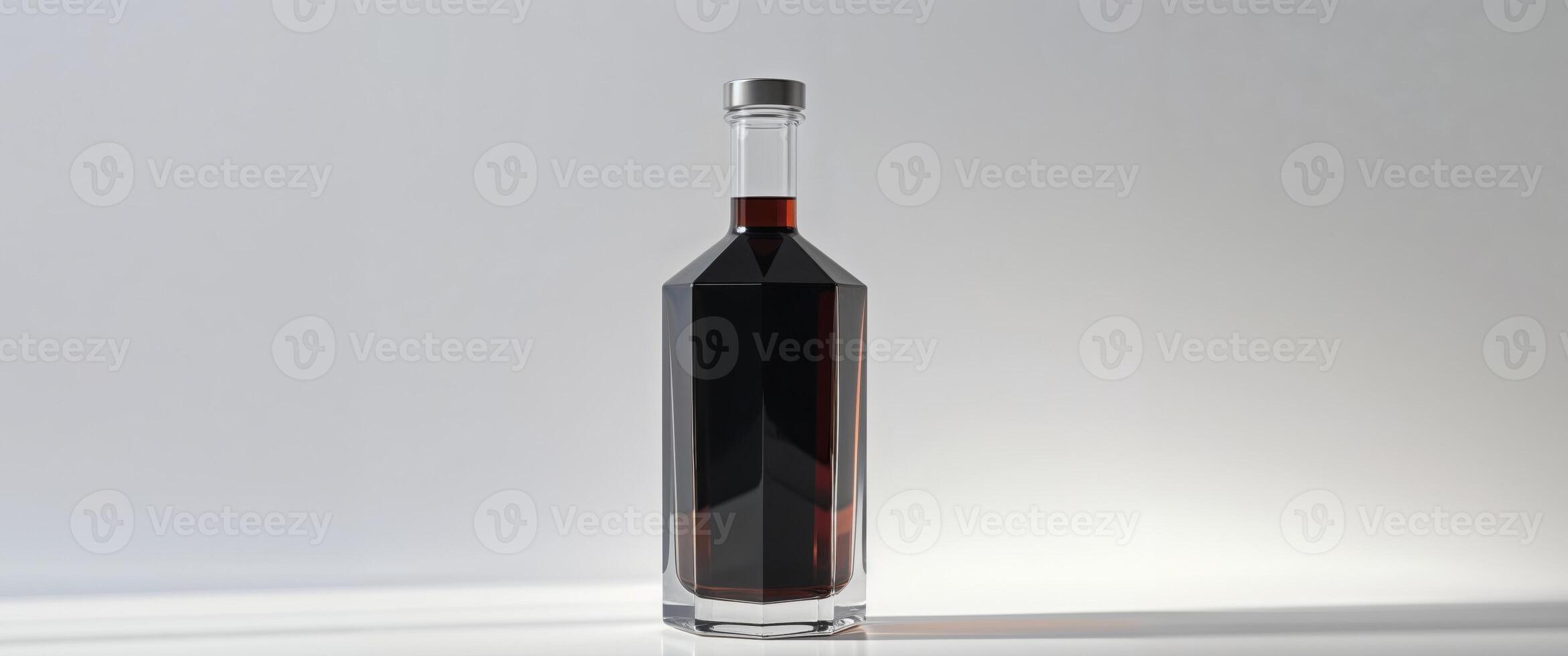 A glass bottle filled with dark liquid perfect for beverage branding and advertising photo