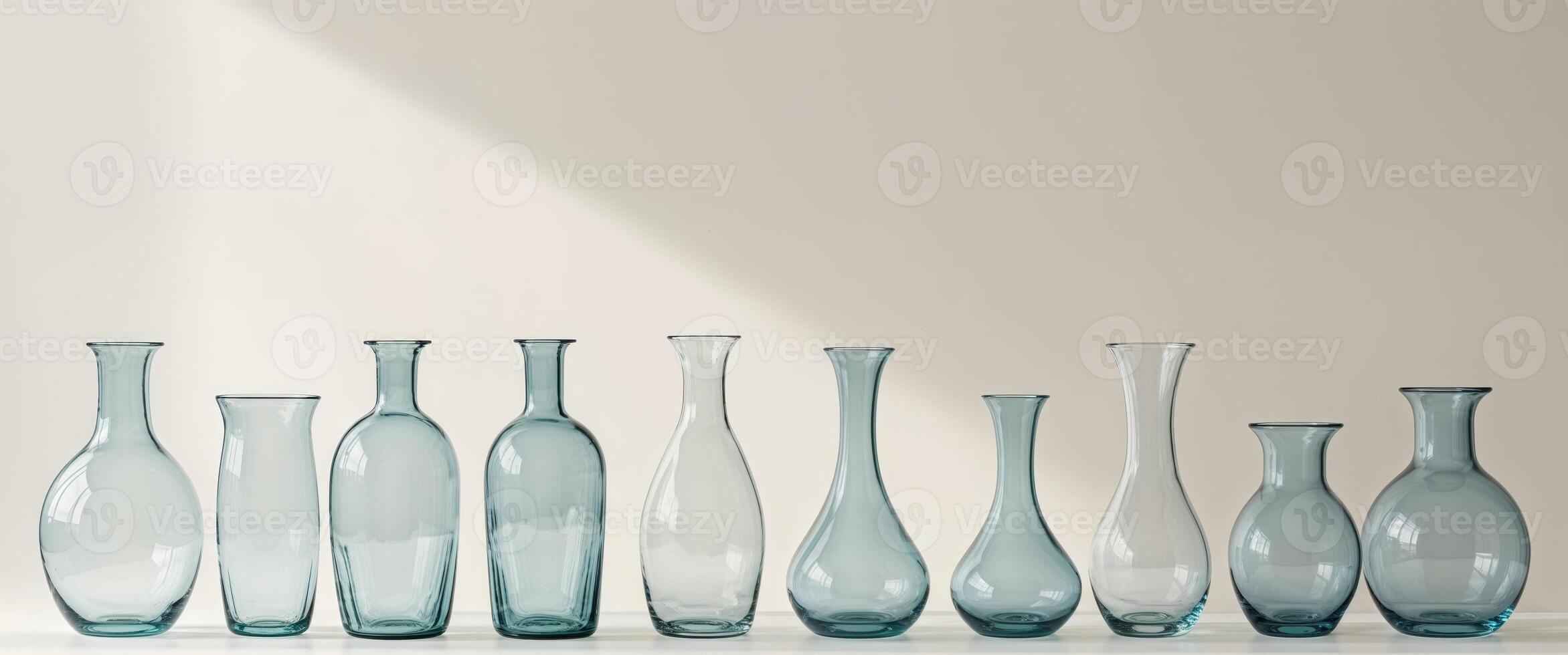 Set of Empty Glass Vases on Light Background. photo