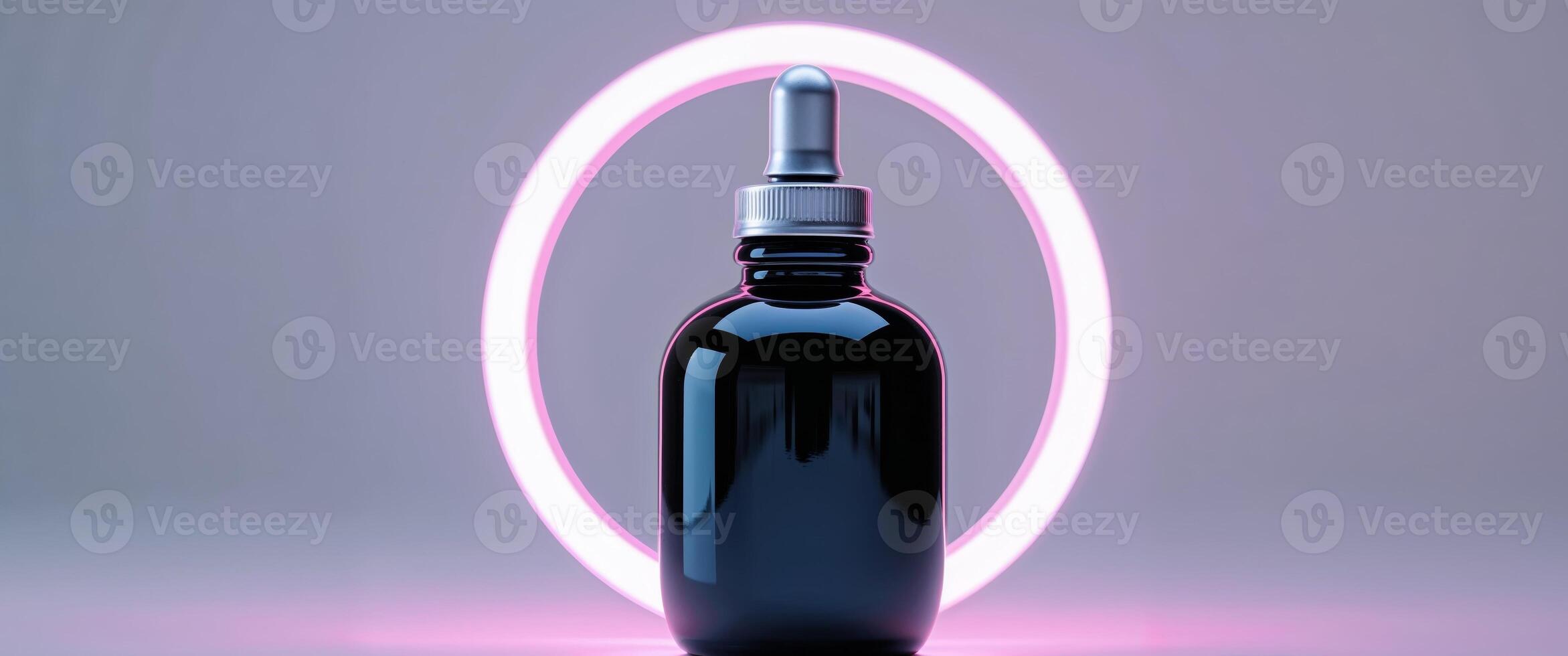 Glossy Black Bottle with Dropper Surrounded by Neon Ring Light photo