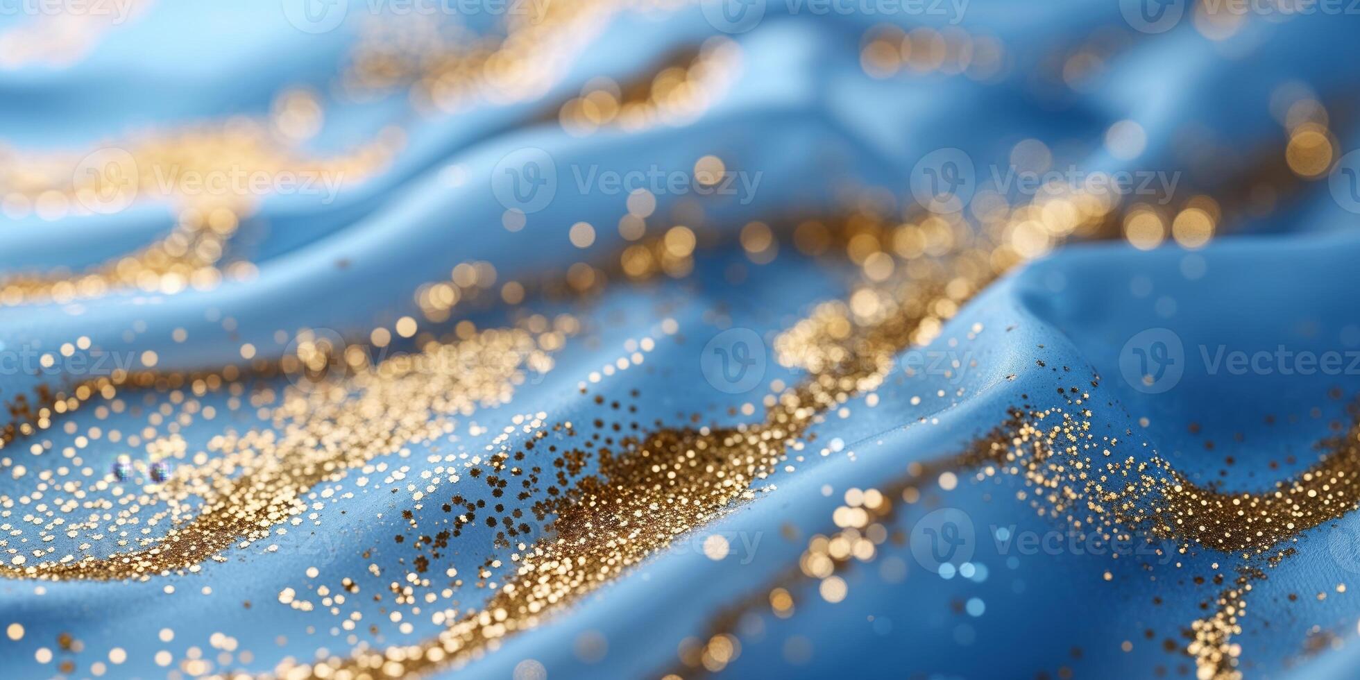 Gold glitter on blue fabric photo