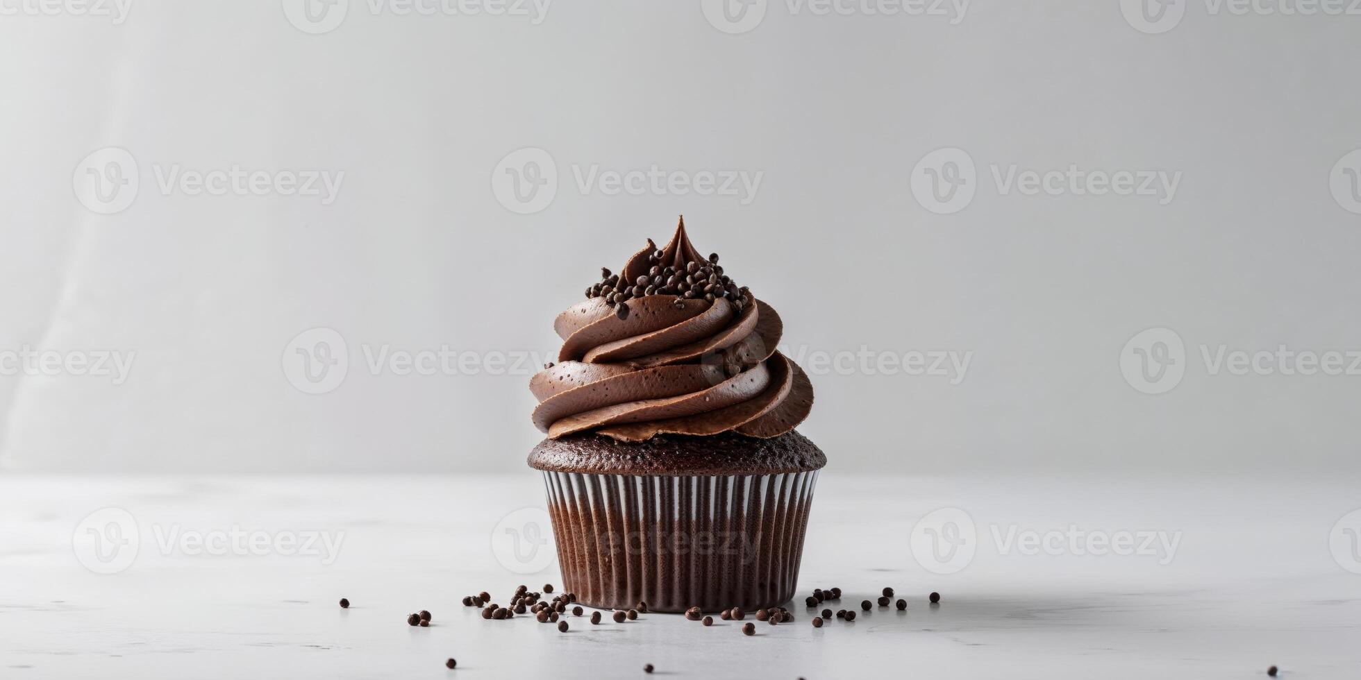 A chocolate cupcake with chocolate frosting and chocolate sprinkles photo
