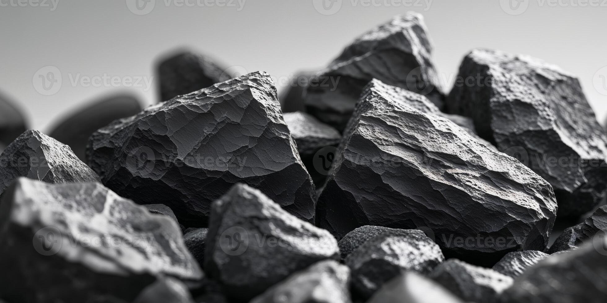 Closeup of raw black stones with jagged textures and natural edges photo