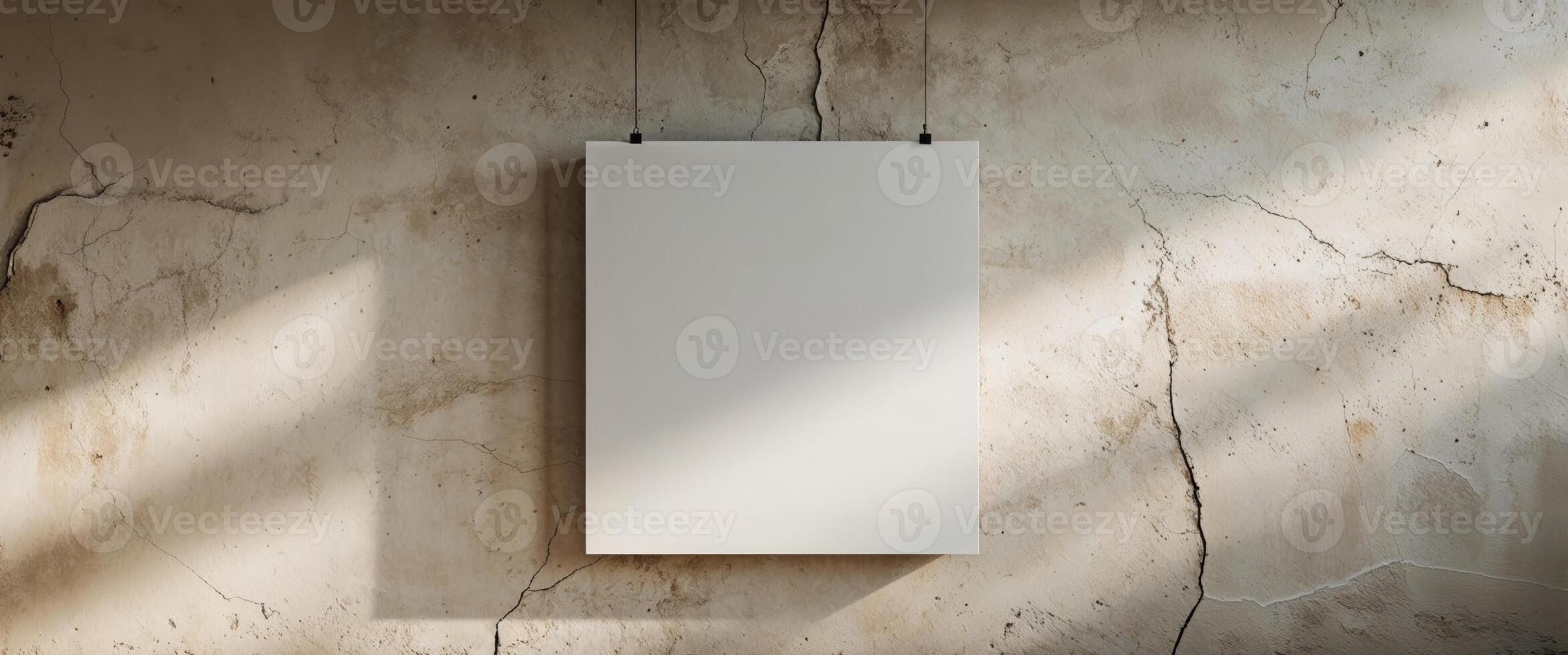 A blank white square sign hanging on a textured light wall photo