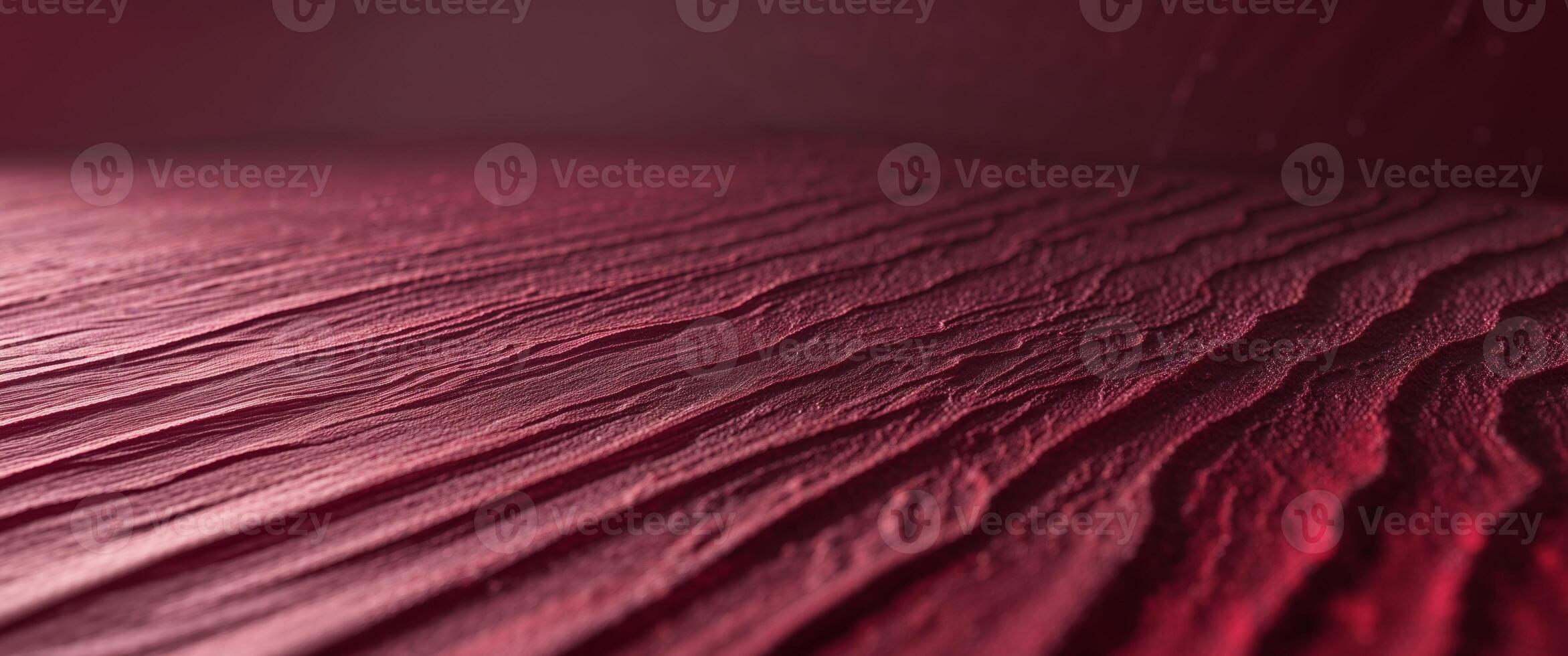 Textured crimson surface with subtle gradient light creating depth and visual interest for backgrounds and designs photo