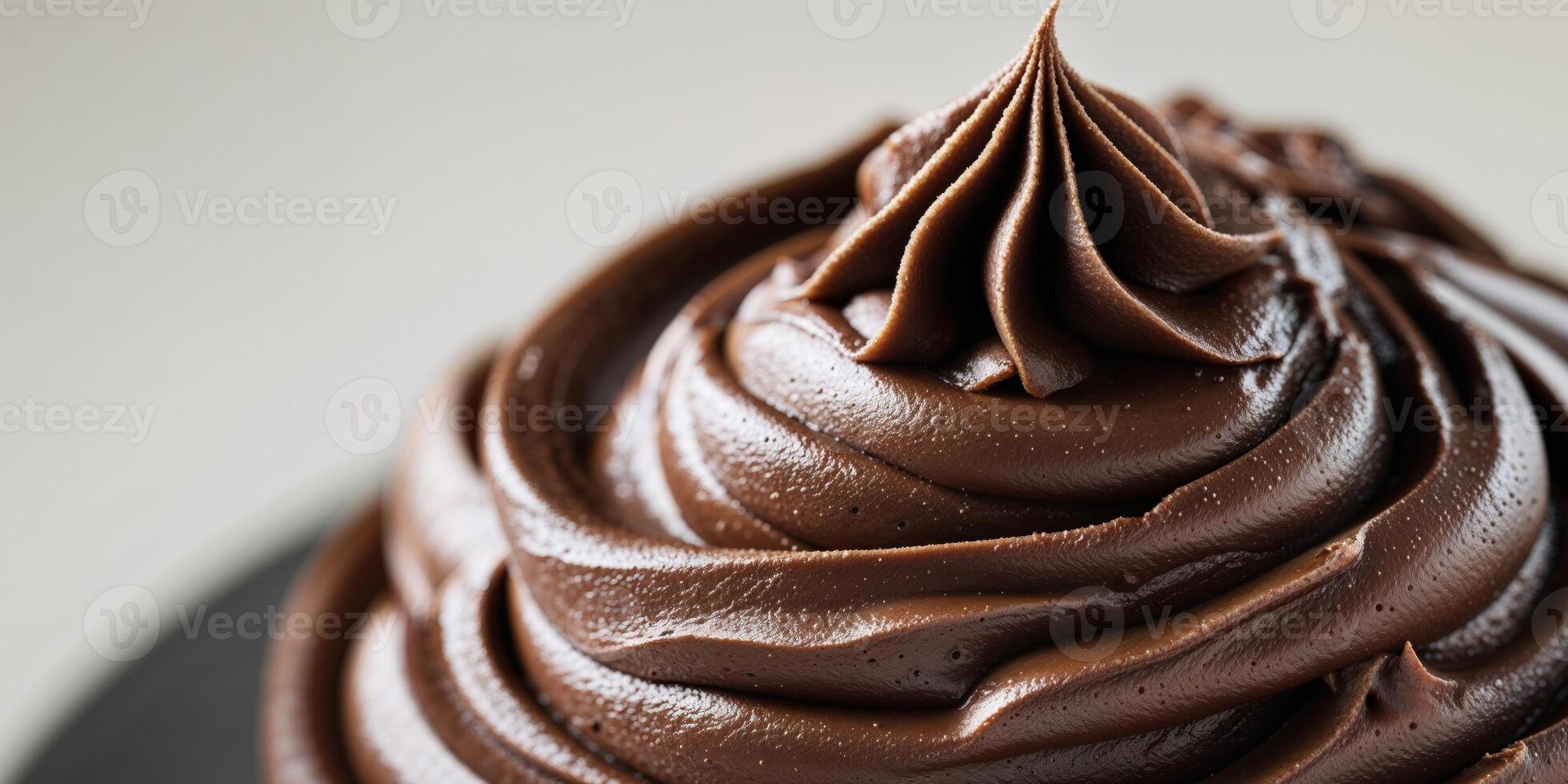 Rich smooth chocolate frosting close up dessert recipes and food blogs photo