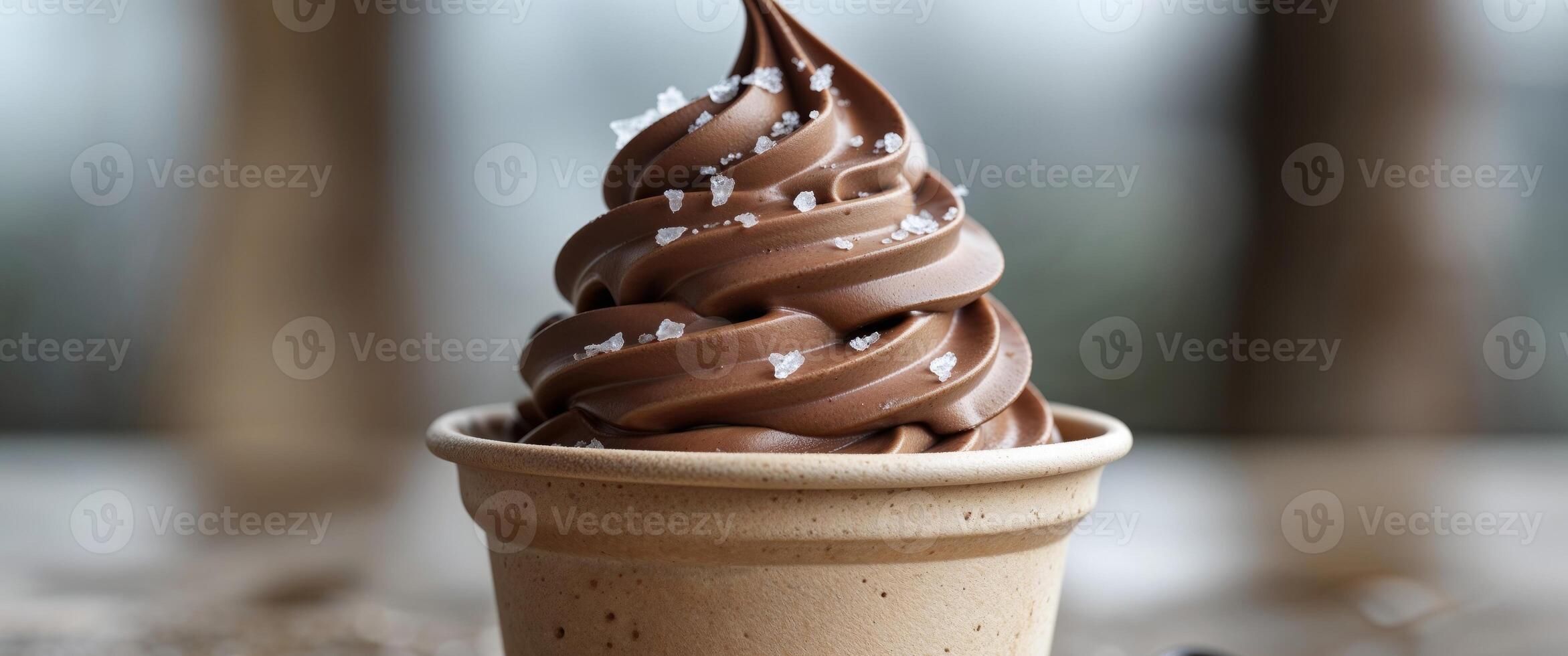 Creamy chocolate soft serve dessert in a biodegradable cup ready to be enjoyed indoors or outdoors. photo