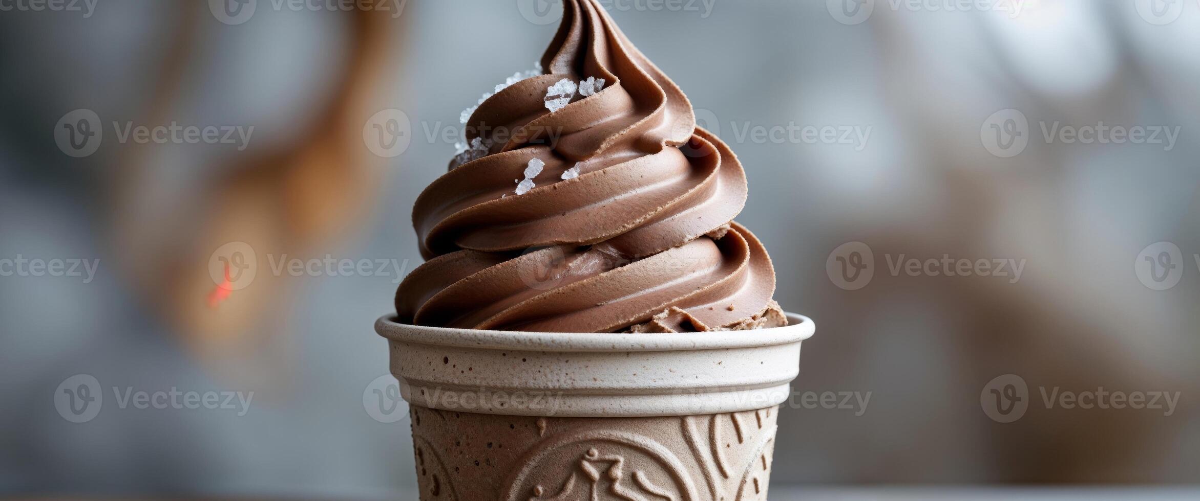 Creamy chocolate soft serve dessert in a biodegradable cup ready to be enjoyed indoors or outdoors photo