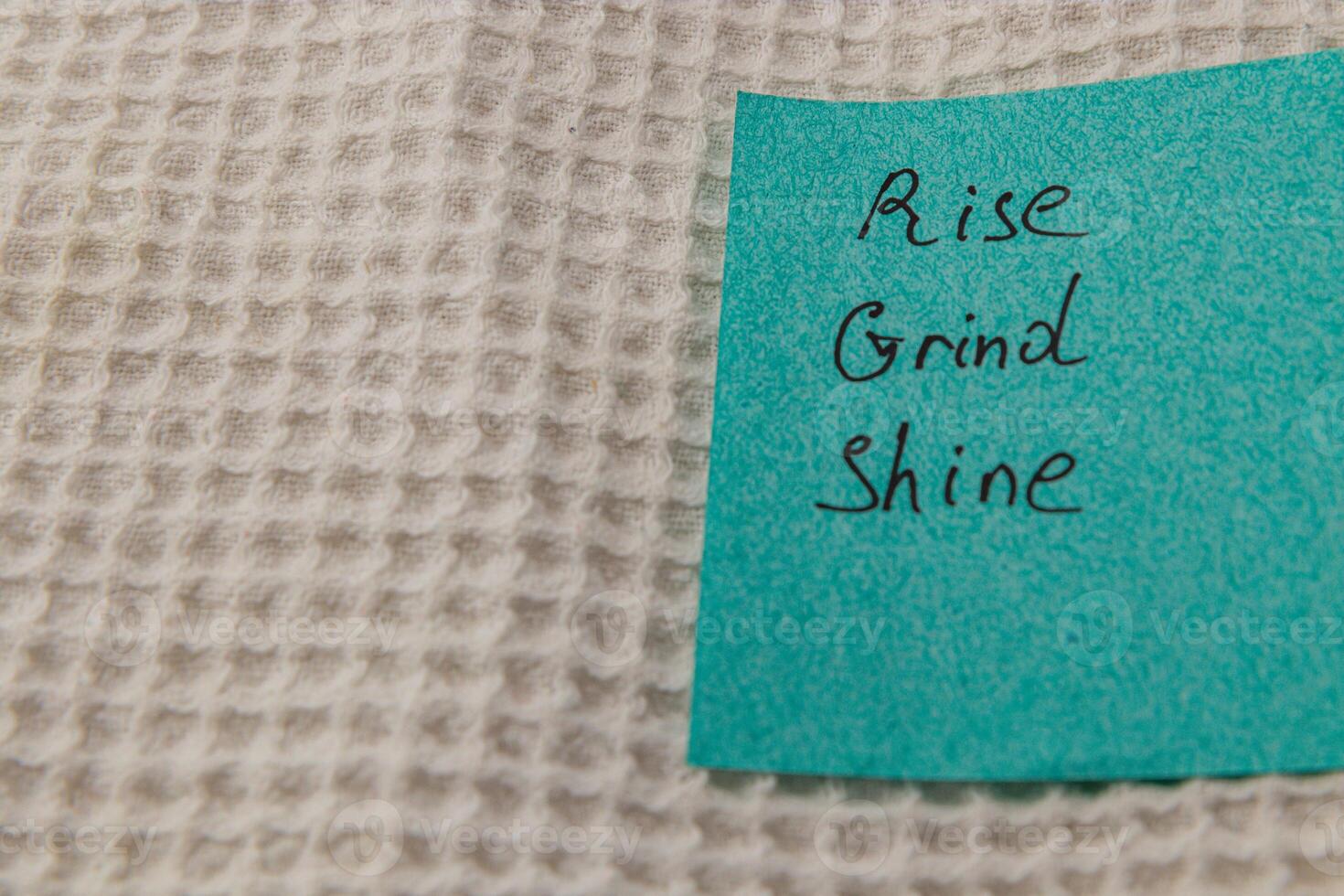 Motivational notes on a blue sticky note placed on textured surface photo