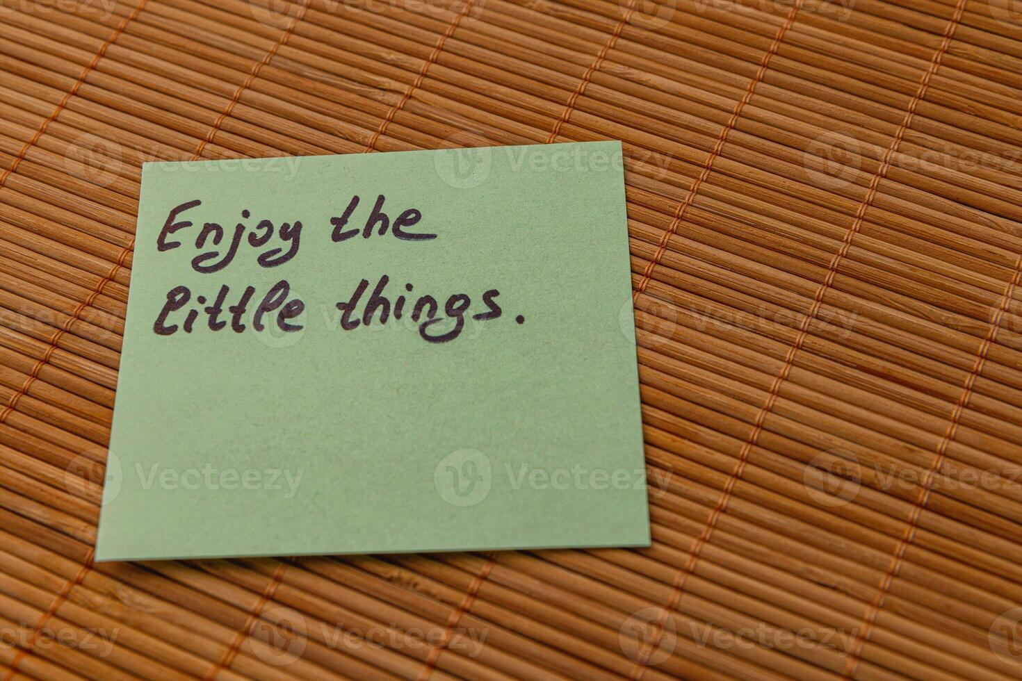 Motivational note about appreciating small joys on a bamboo mat photo