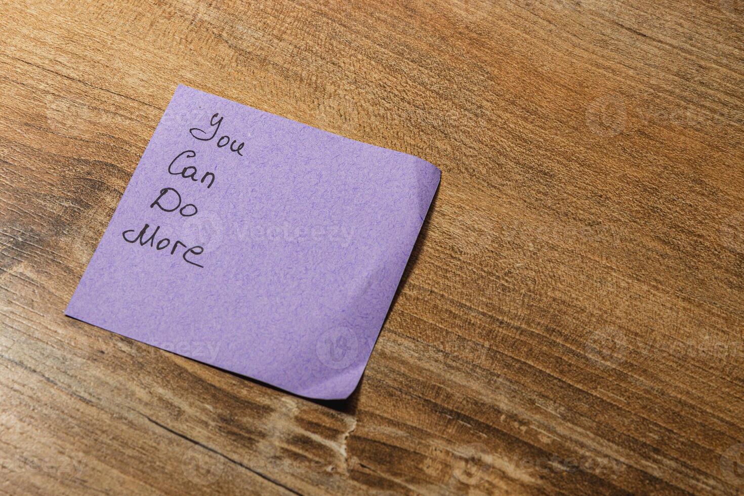 Encouraging note on a wooden table inspires motivation and reflection photo
