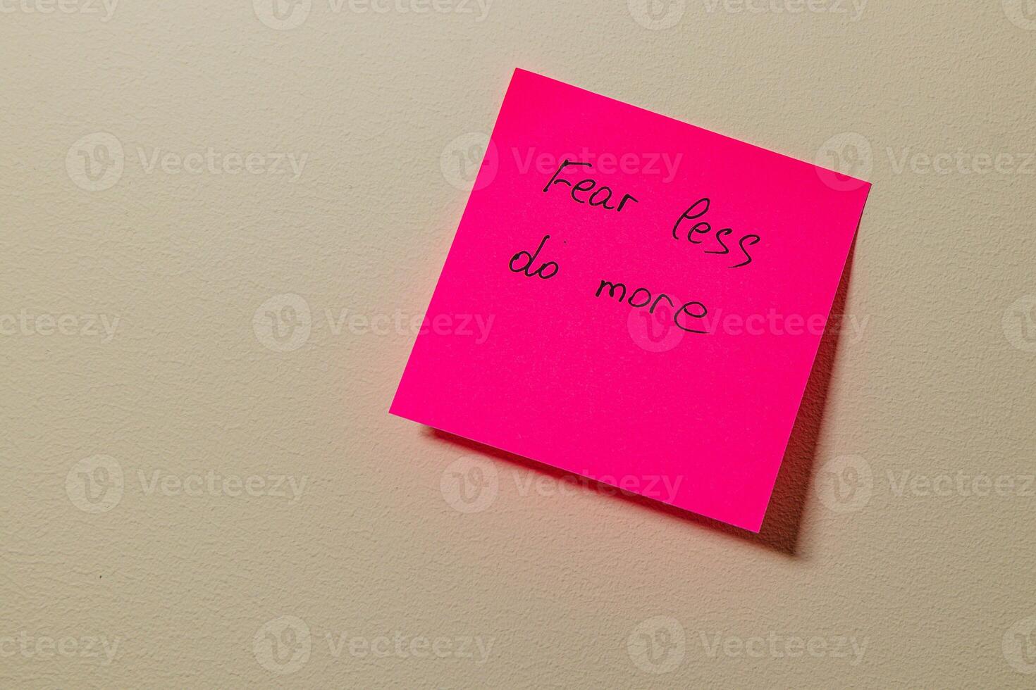 Motivational note on a wall encourages taking action and overcoming fear photo