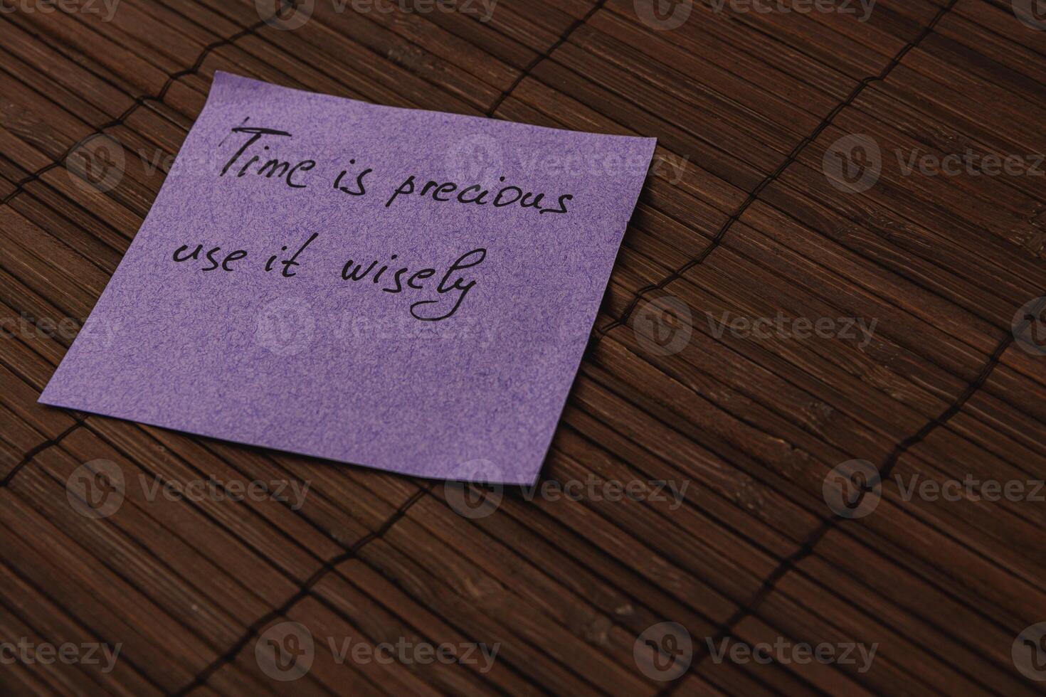 Note on a wooden surface conveying a thoughtful message about time management photo