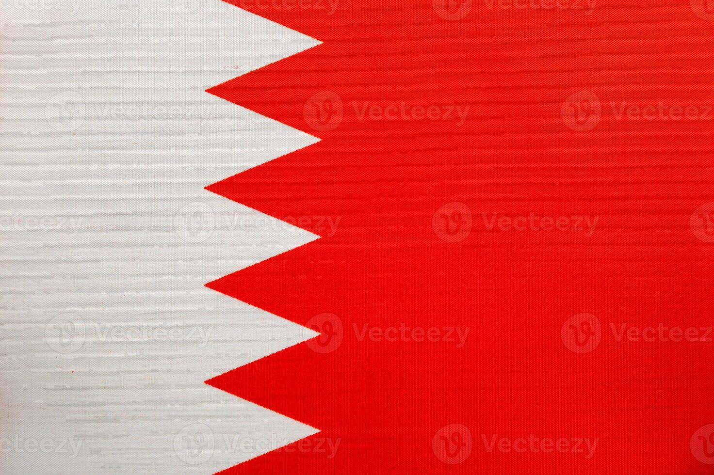 Bahrain national flag displayed against a blue background photo