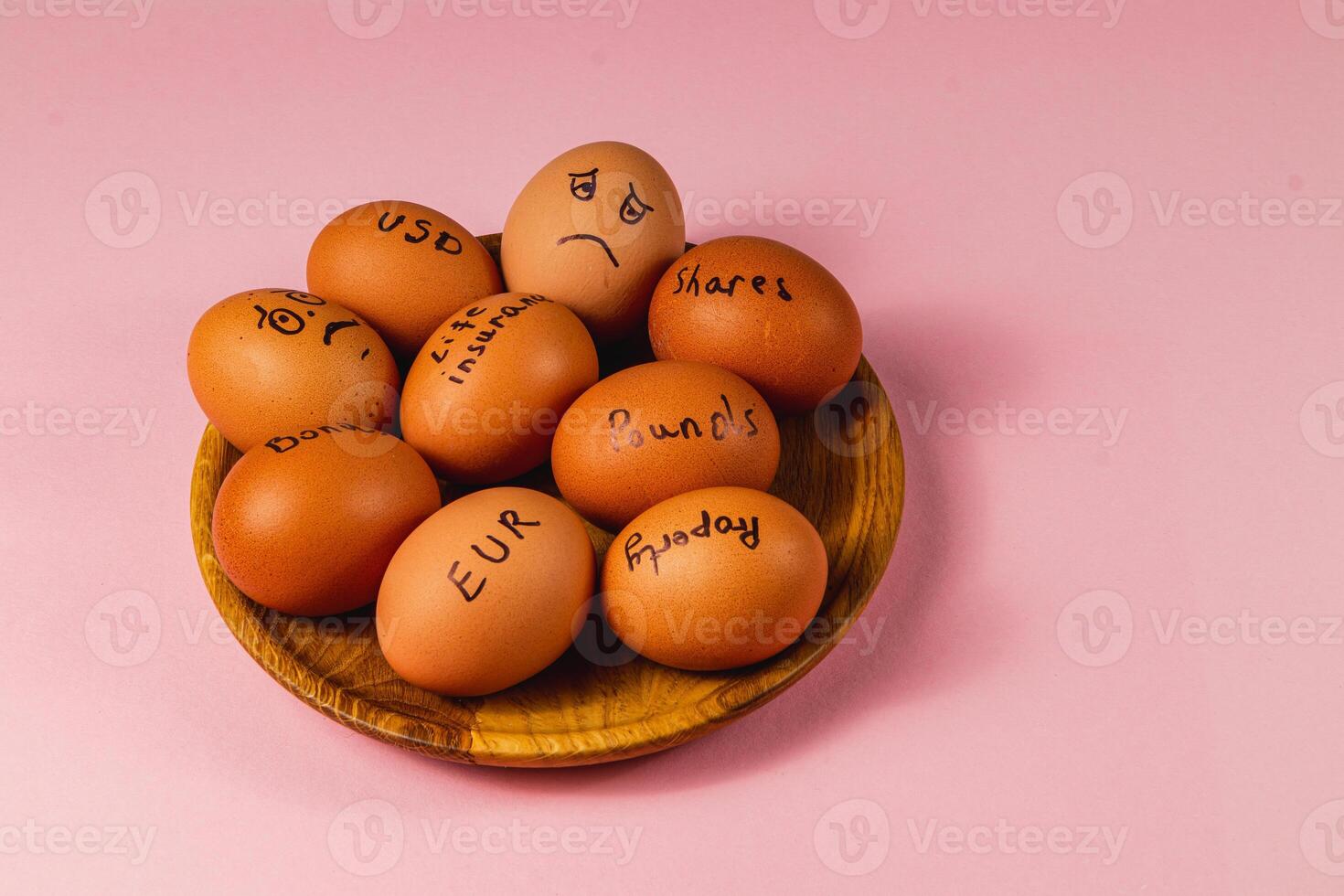 Investment lessons illustrated with eggs on pink background photo