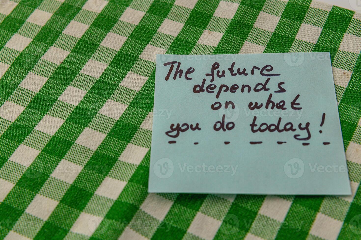 Motivational note placed on checkered tablecloth for daily inspiration photo