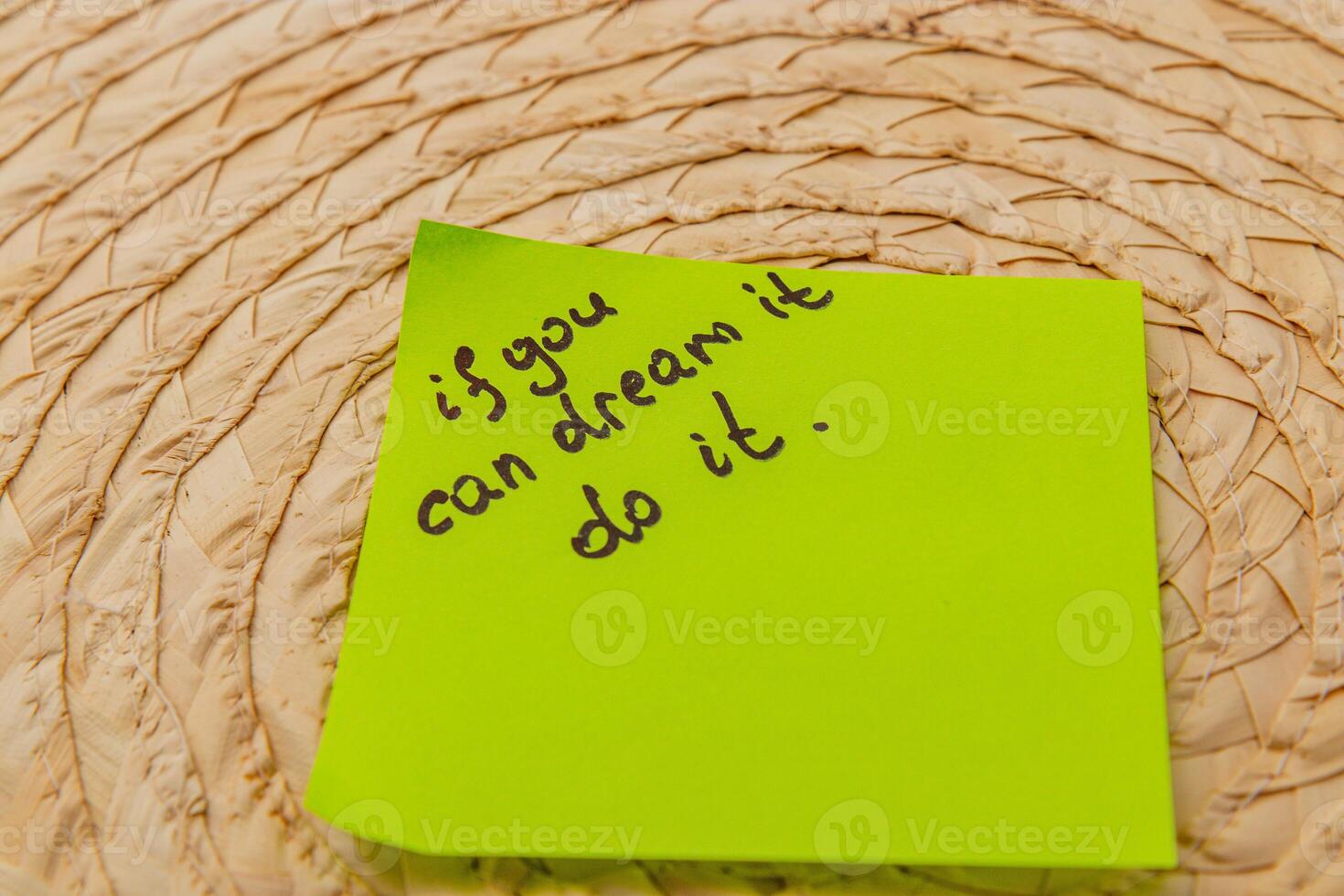 Inspiration note on bright sticky pad placed on woven surface in cozy setting photo