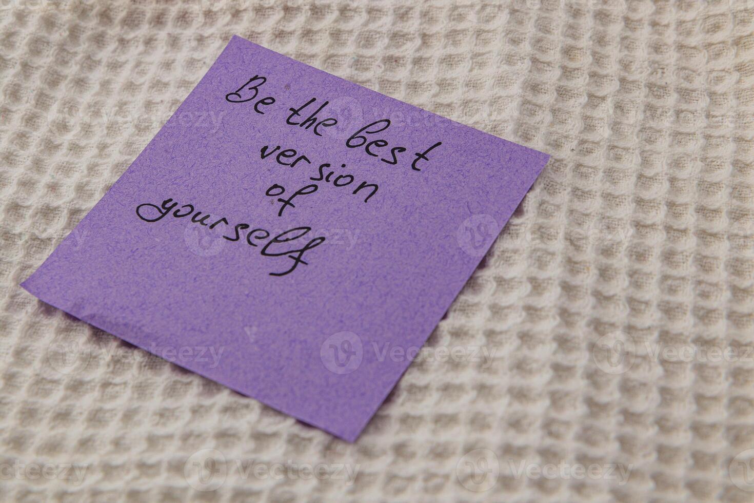 Encouraging note on a purple sticky reminder resting on fabric photo