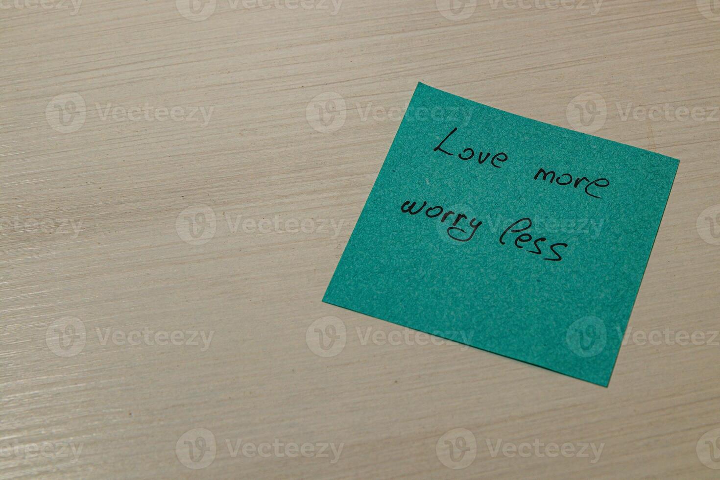 Turquoise note love more, worry less. photo