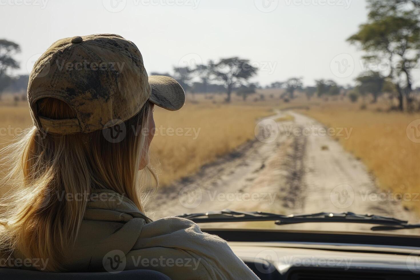 Caucasian woman on african safari adventure in open-top jeep photo
