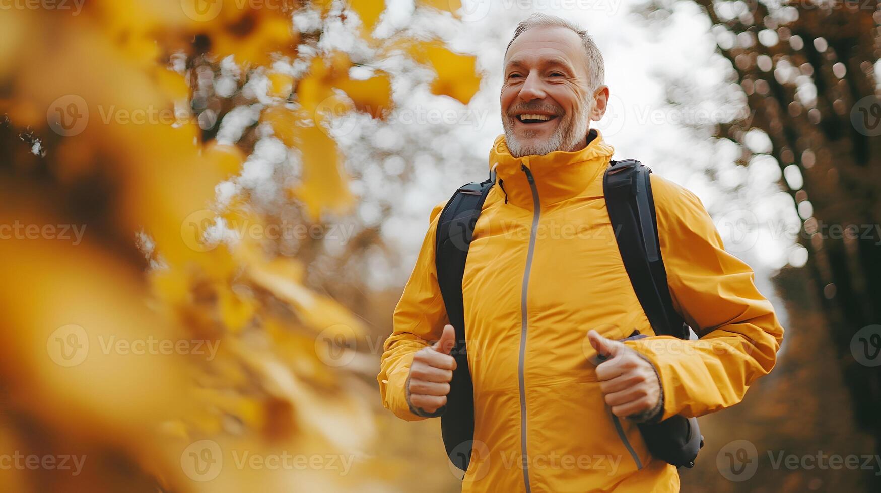 Older man jogging past autumn trees, happy expression, fitness for all ages message photo