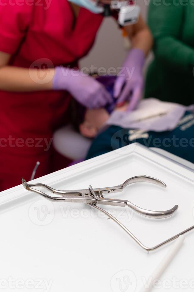 Surgeon performs intricate dental procedure with precise instruments and attentive care at a modern clinic, creating a comfortable environment for the patient photo