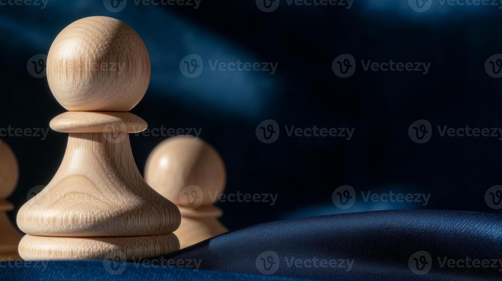 Wooden chess pieces on a blue cloth photo