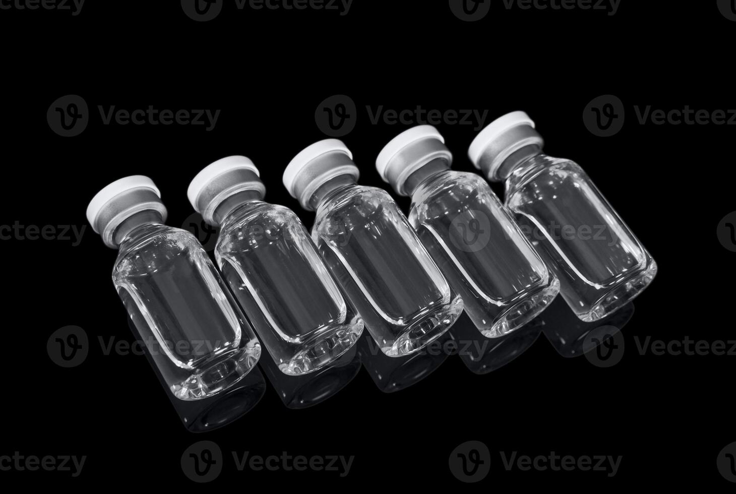 Vials with solution for injection on a black background photo