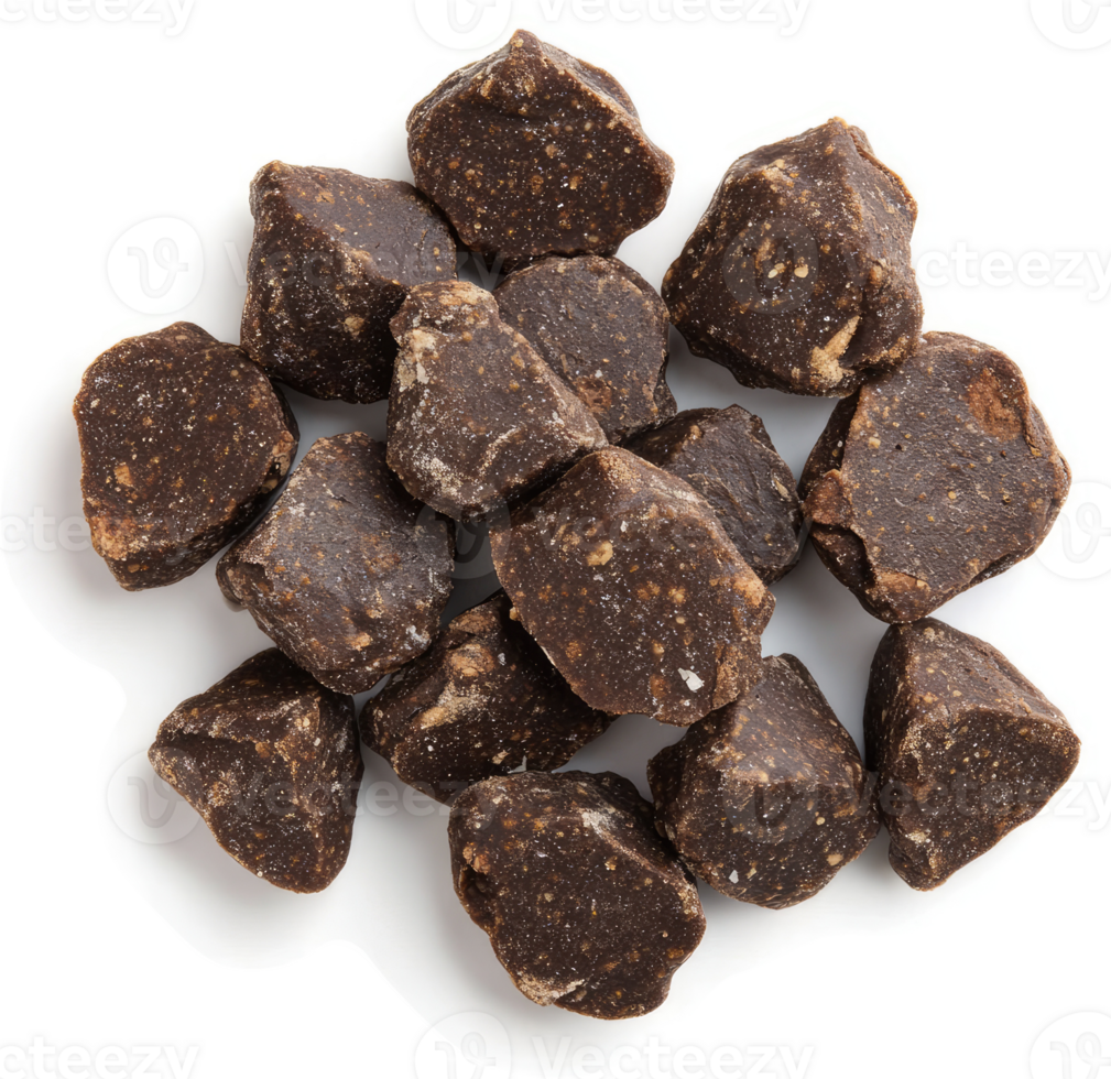 Dark chocolate chunks scattered on a white surface. png