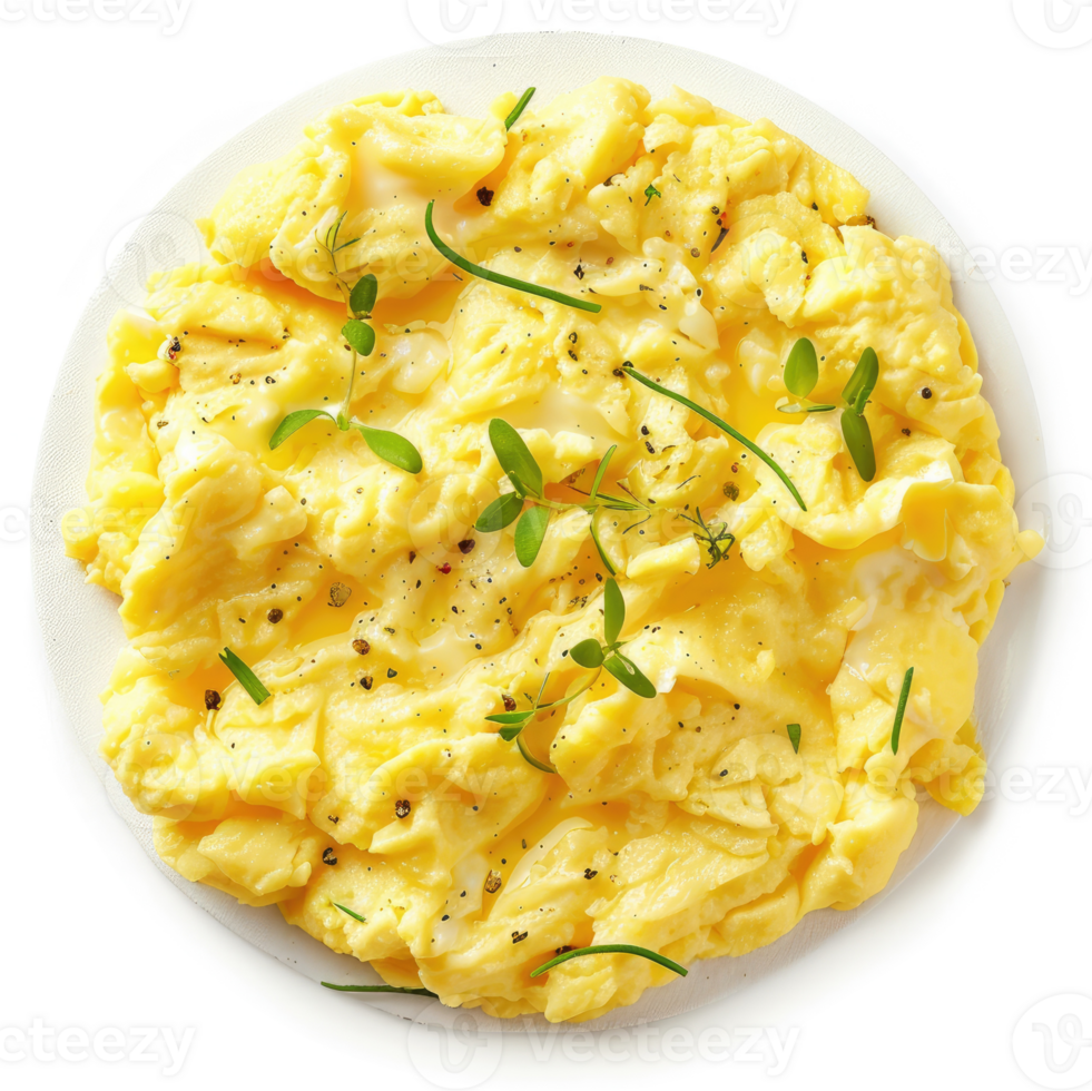 A plate of scrambled eggs garnished with fresh herbs and pepper. png