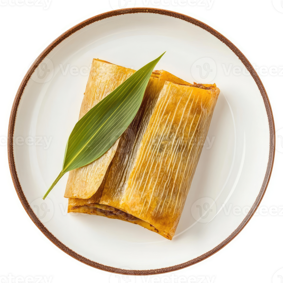 Golden tamale resting on a plate with a decorative leaf. png