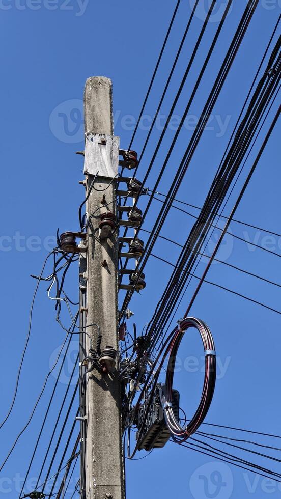 A telephone pole with many wires attached to it photo
