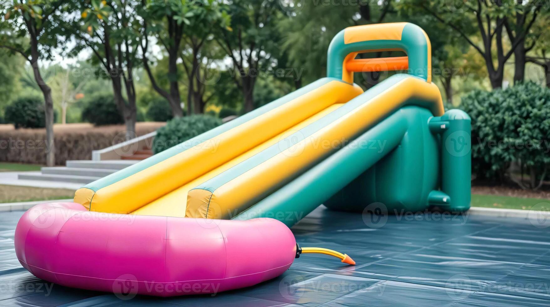 Inflatable water slide with a green and pink slide photo