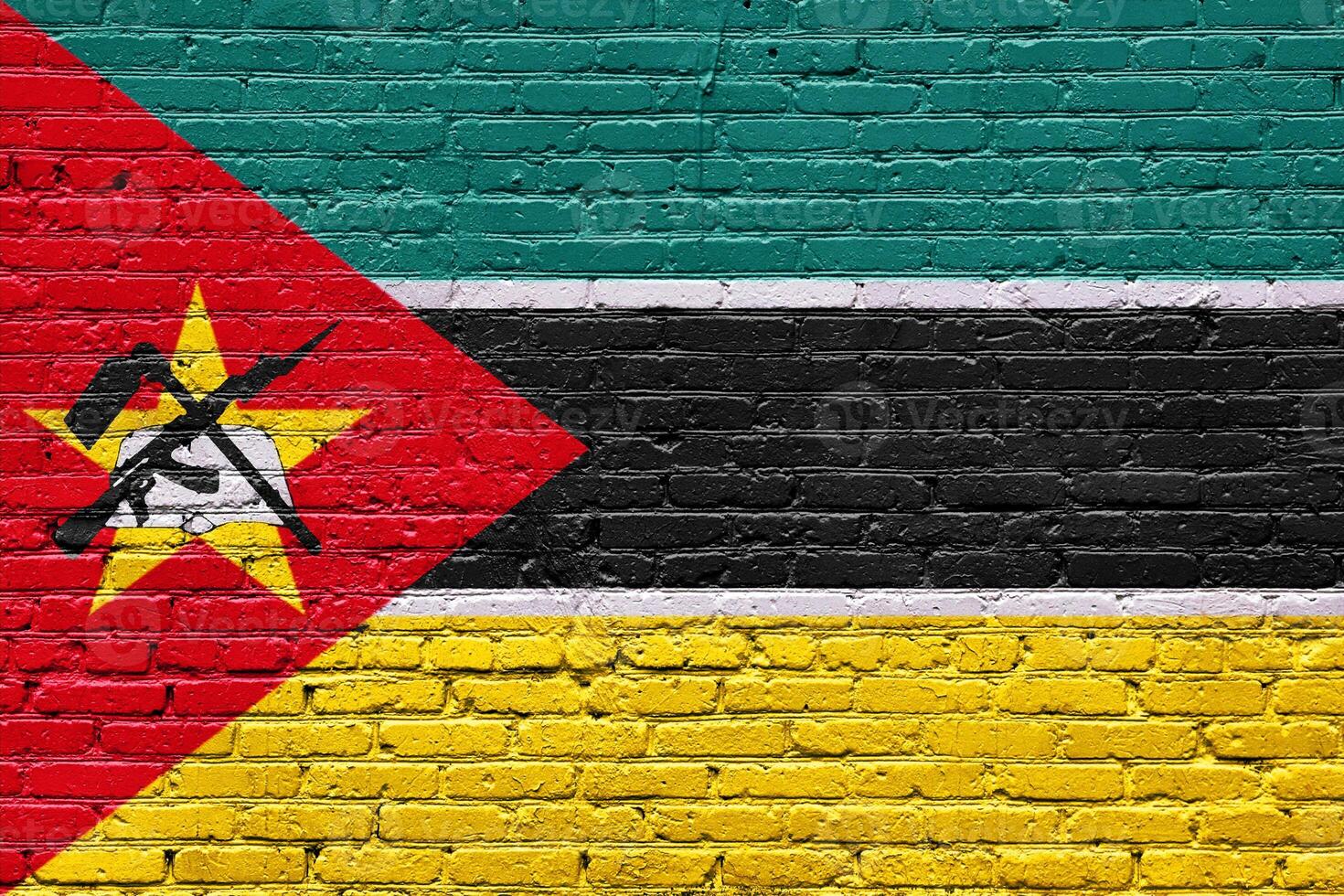 mozambique A grunge wall texture displaying old national symbols in red, white, and abstract patterns photo