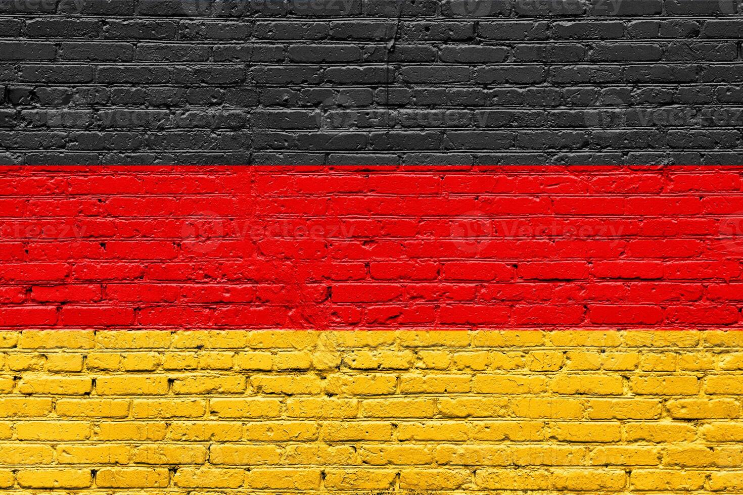 Grunge Germany flags painted on an old brick wall with textured patterns photo
