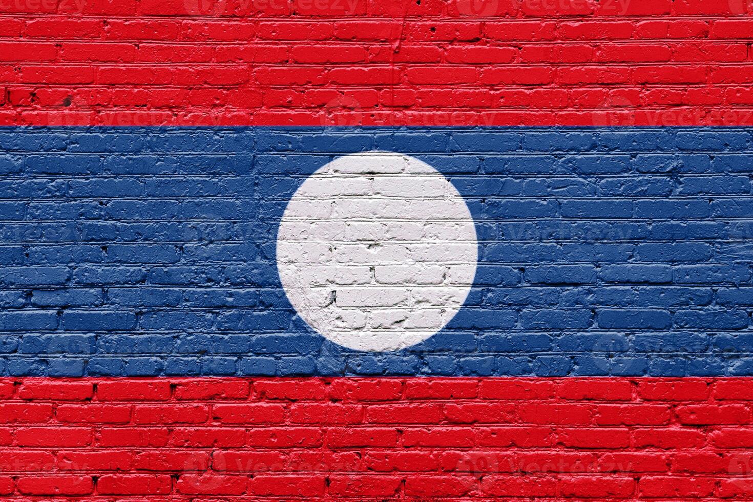 Grunge style wall with the flags of laos lao painted in an aged and textured pattern photo