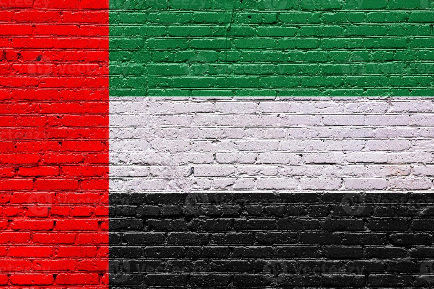Flag of united arab emirates on an old brick wall with textured, weathered surface photo