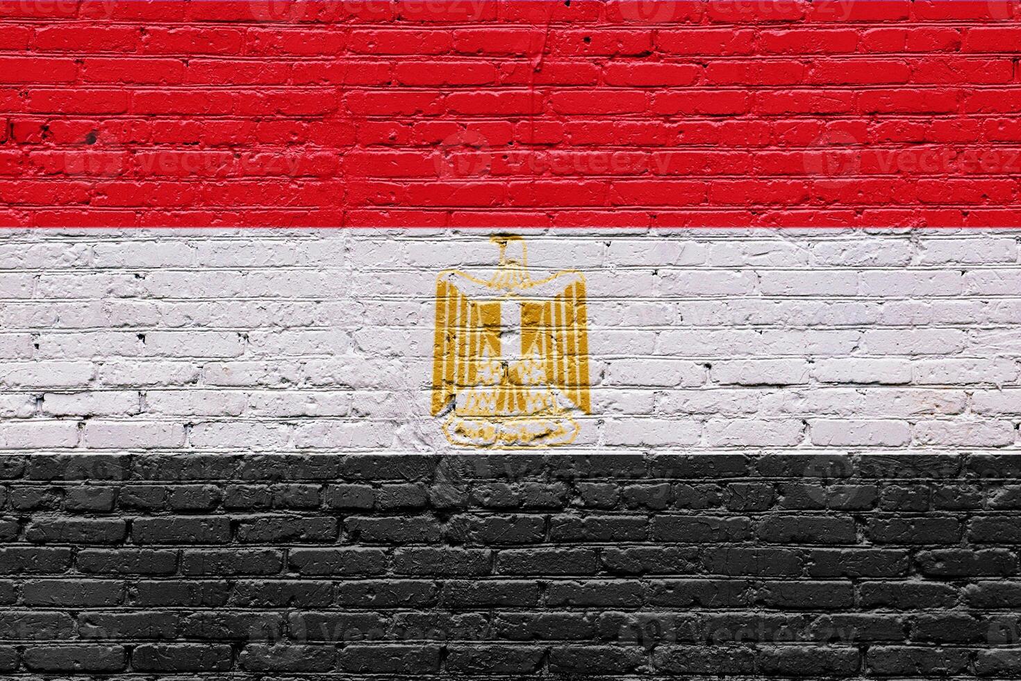 Flag of Egypt on an old red and yellow brick wall with textured and rough bricks photo