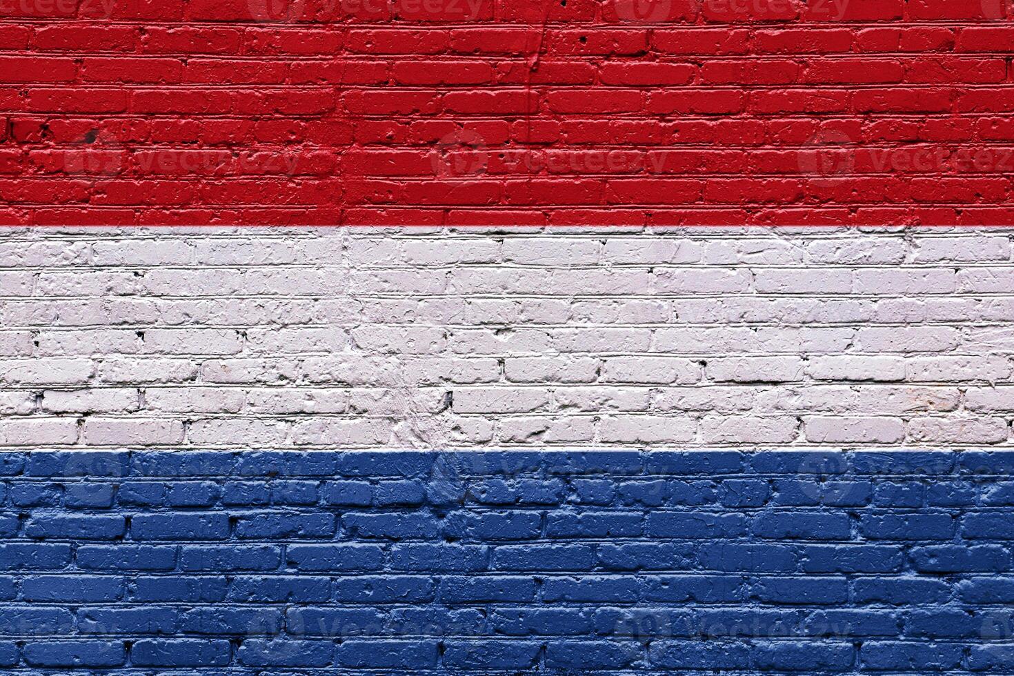 Red brick wall with netherland flag and white brick section photo