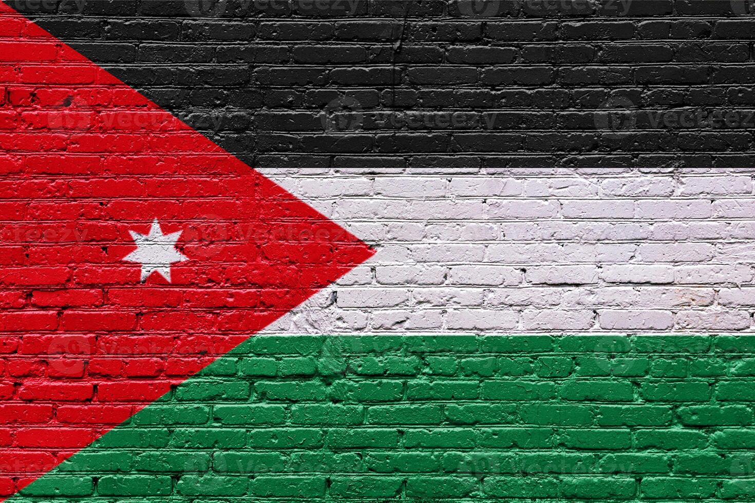 Grunge flags of jordan on a textured brick wall with patriotic symbols and abstract patterns photo